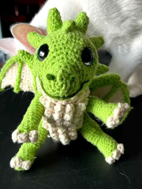 Hand-crocheted green dragon with small wings