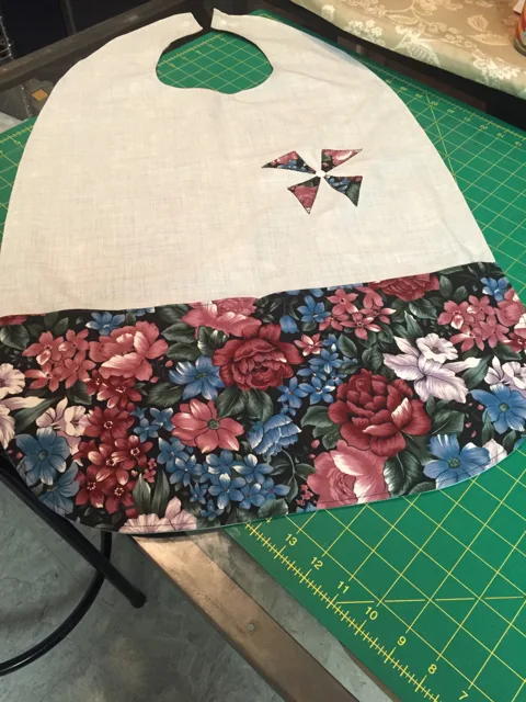 Handmade adaptive bib with cream fabric and a floral panel